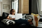 Photo of woman sitting on a couch 4100959