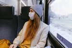 Woman in gray knit cap and beige coat 3962212