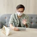 Man wearing a face mask having a video call 4031817
