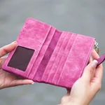 Person holding pink suede long waller 910122