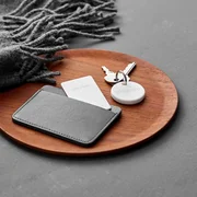 Chipolo ONE attached to keys and Chipolo CARD inside a wallet